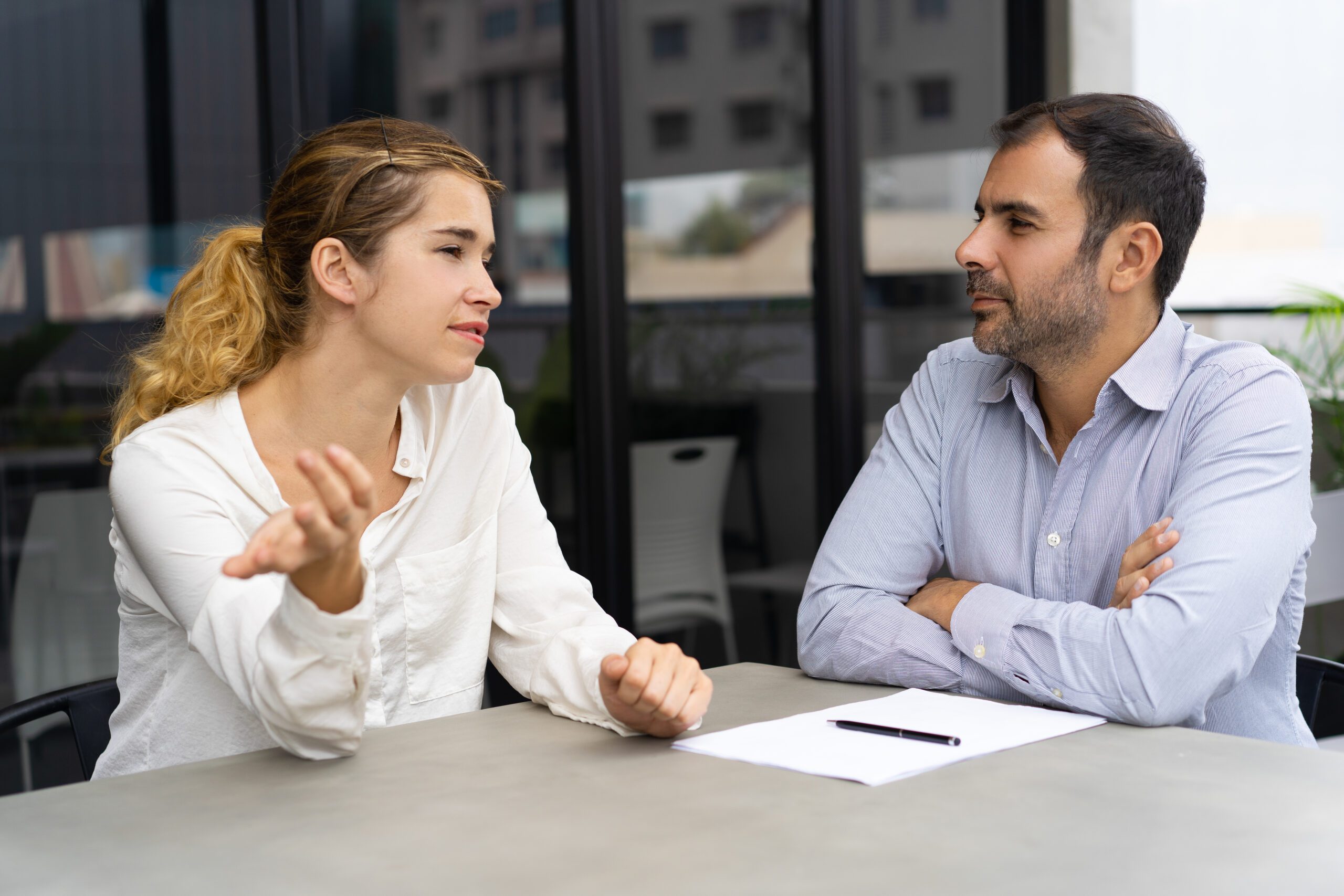 Confident female candidate meeting with company leader crucial conversations
